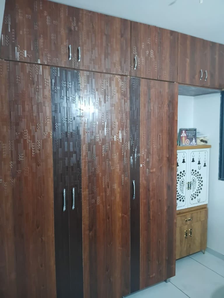 8-Door Wardrobe with Laminate & Glass Panels - custom furniture project by MistriKaam in New Ranip, Ahmedabad